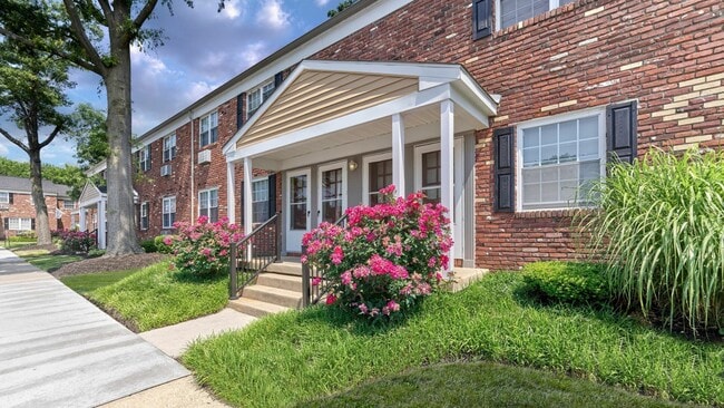 Beautiful red brick exterior and vibrant landscaping at Maple Terrace Apartments in Maple Shade, NJ
