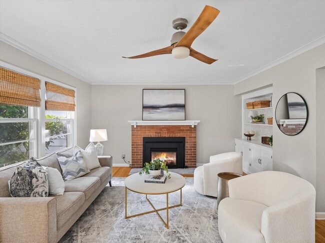 The living room features a gas fireplace and ceiling fan.