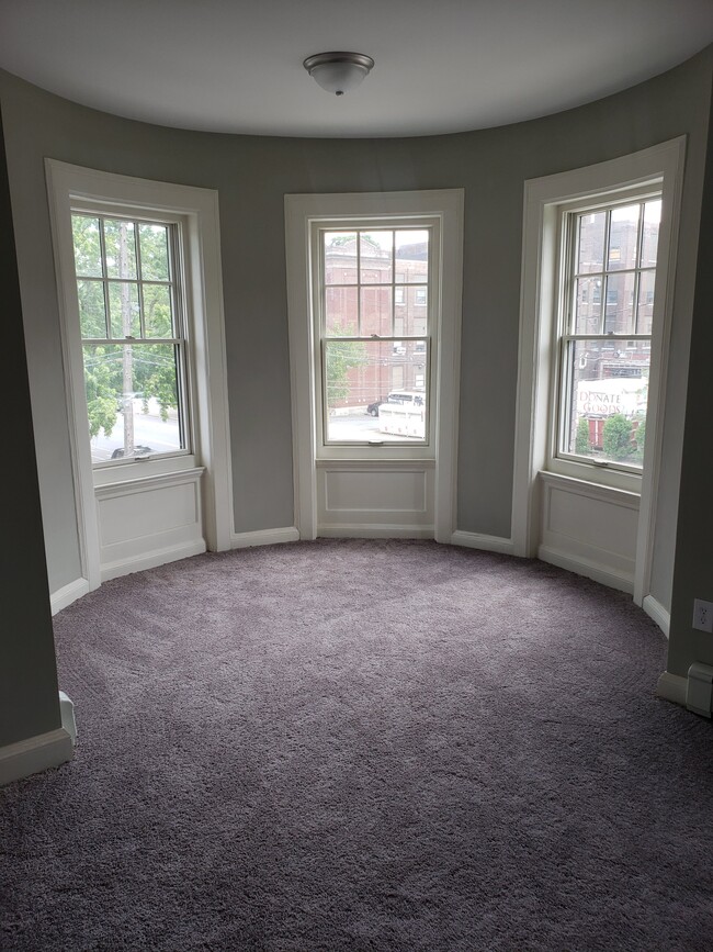 Large master bedroom, measures approx. 20 ft by 20 ft. Bedroom has four windows. - 2 Judson St Apartments Unit 2