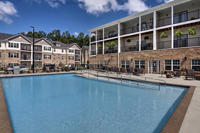 Outdoor pool with lounge chairs at Retreat at the Park apartments for rent in Burlington, NC - The Retreat at the Park