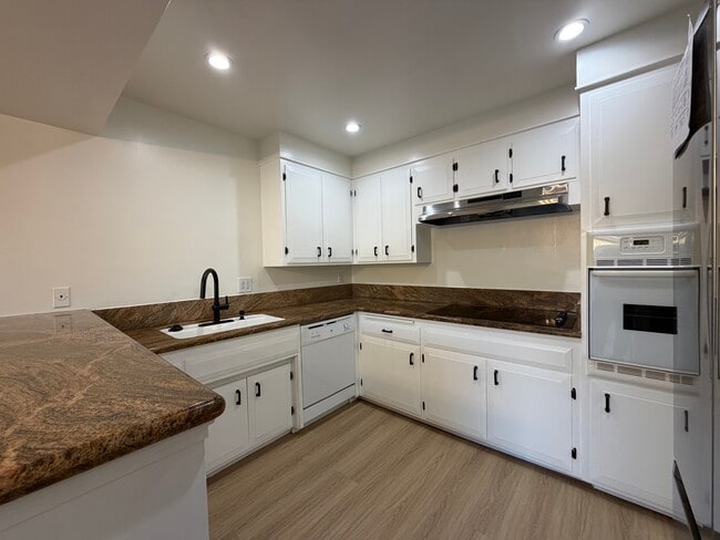 Kitchen with Ceramic Cooktop & Large Stainless Steel Fridge - The Huntington Sunset