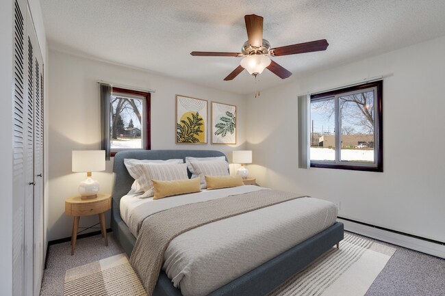 Welcome to St. Anthony Group, where modern comfort meets stylish design. This cozy bedroom features ample natural light, a ceiling fan for your comfort, and a serene atmosphere. Don’t miss your chance to call this home—contact us today!