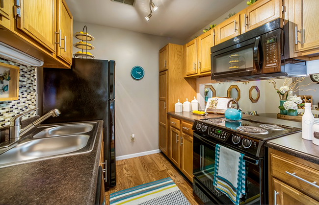 Galley Style Kitchen with Upgraded Appliances - Westchase Apartments