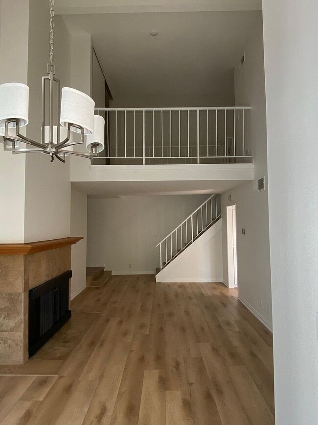 Living room with chandelier and fireplace - 8305 Summertime Ln Unit 8305