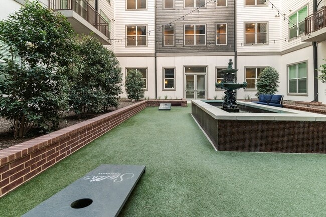 Main courtyard features a boutique, infinity-edge swimming pool and outdoor fire place