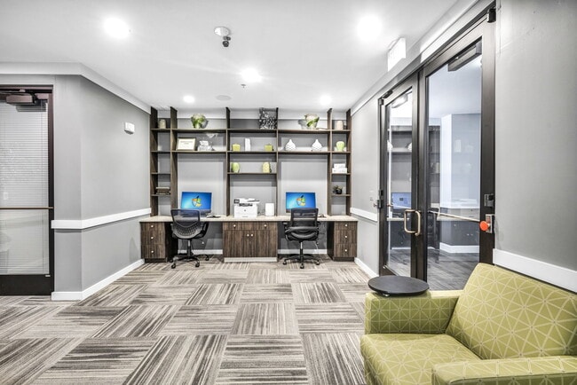 A work space with a green sofa and desk space at Markethaus 3700 in Plano Texas