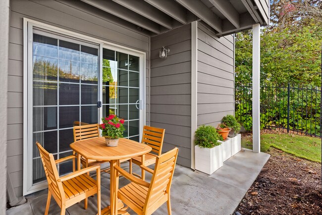 Relax on this charming patio, perfect for outdoor gatherings and peaceful moments. - Monte Vista Apartments