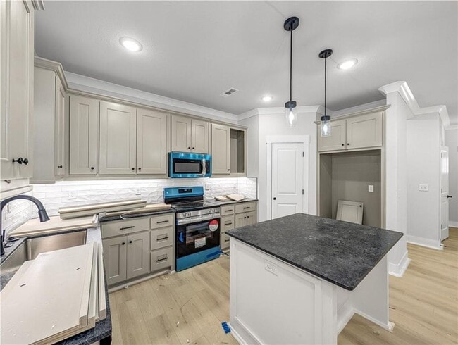 Photo - Modern open-concept living meets peaceful nature views in this custom-crafted retreat.