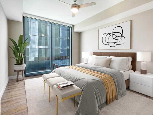 Spacious bedroom retreats feature modern ceiling fans, wood plank style flooring, and oversized windows for a bright and calming atmosphere.
