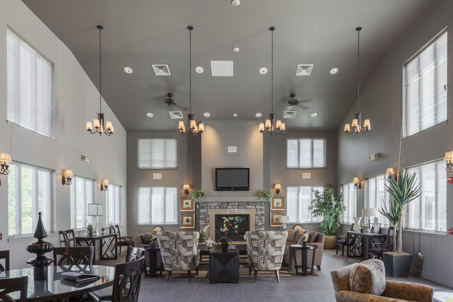 Modern Resident Clubhouse with Lounge Seating and Fireplace - Quail Run Apartments