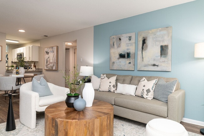 Spacious living room with hardwood-style flooring & ceiling fan