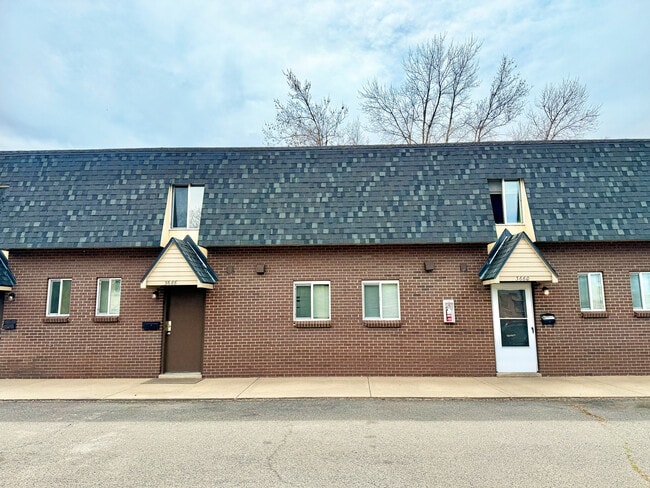 Charming brick townhouse exterior with modern windows and distinctive roof design, ideal for comfortable urban living. - 3650 Upham
