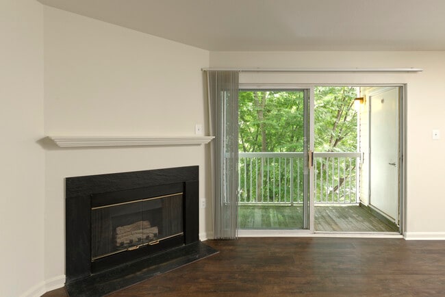 Living area with hard surface flooring, fireplace and balcony