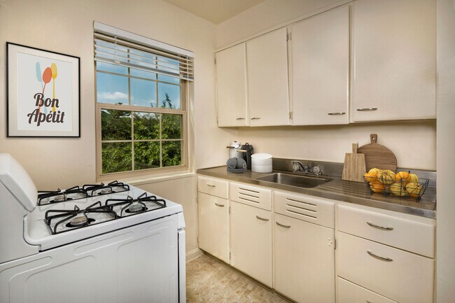 Kitchen with gas stove at Goodacre & Pine Ridge Apartments in Silver Spring, MD