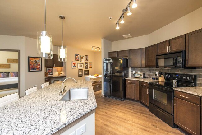 Luxurious Kitchen with Large Island, Pendant Lighting and Designer Tile Backsplash | Nashville Tennessee Apartments for Rent | 909 Flats - 909 Flats