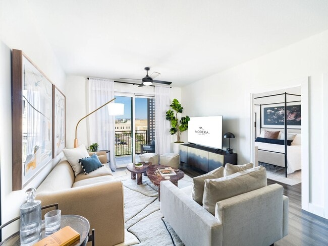 Natural light fills the spacious living area, which opens directly to your private balcony and flows seamlessly into the adjacent bedroom. - Modera Kierland