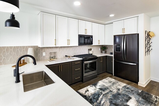 Kitchen with Gas Range Stovetops and Stainless Steel Appliances - Harlowe
