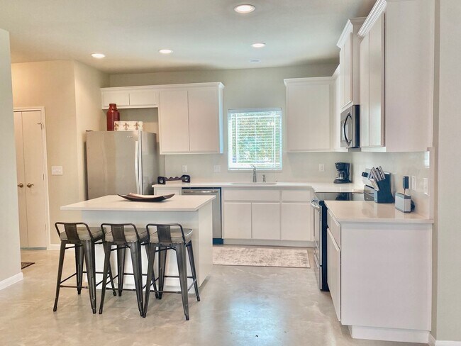 Photo - This charming two-story home, built in 2018, offers a spacious open floor plan perfect for casual...