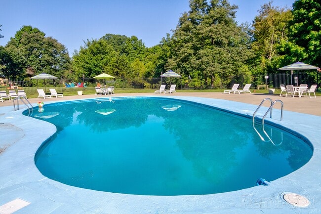 Inviting outdoor pool area with sun loungers and umbrellas, perfect for relaxation.