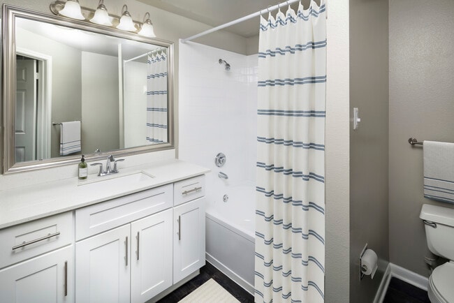 Classic Package II bath with white quartz countertop, white cabinetry, and hard-surface flooring