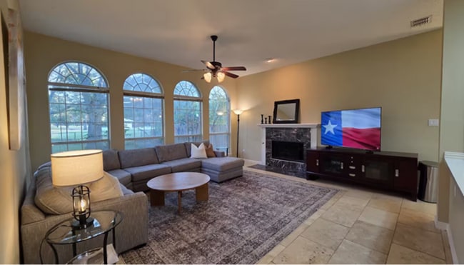 Morning light spills through floor-to-ceiling windows in this first-floor family room