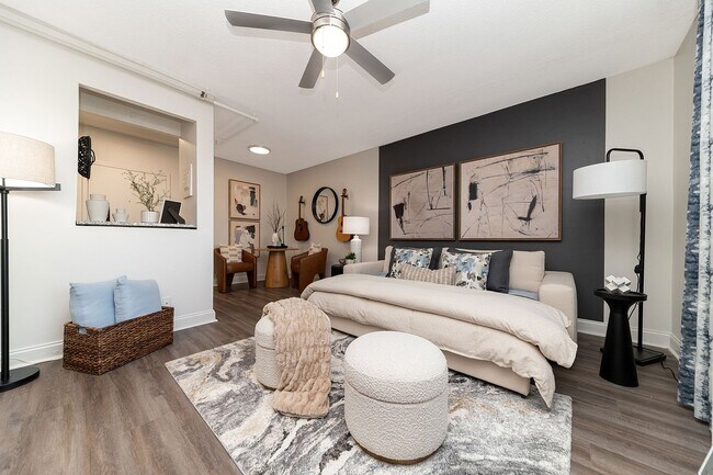Spacious open living & sleeping area with hardwood-style flooring & ceiling fan