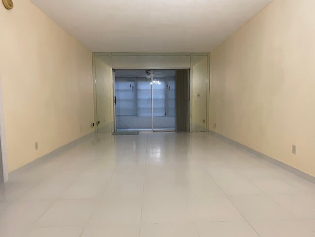 Looking from dining room area toward living living room and sun room - 2900 NW 47th Terrace Unit 103