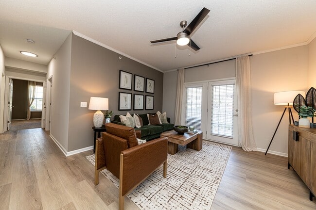 Spacious living room with hardwood-style flooring & overhead lighting