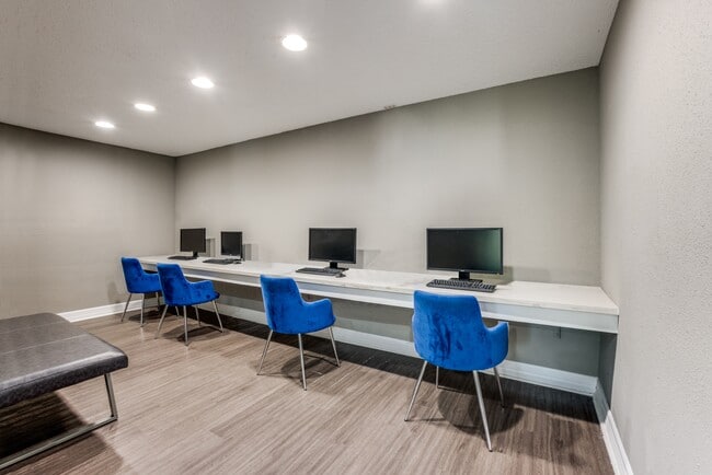 Business center with four open computers for resident use