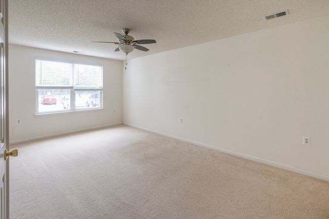 Bedroom with natural light and ceiling fan - 10024 Vanderbilt Cir Unit 1