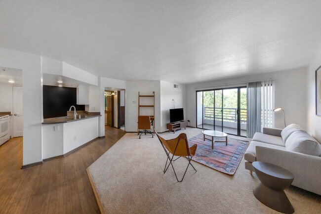 Furnished+ apartment homes come outfitted with a sofa, side chair, side table, coffee table, TV stand and 50" Television (Representative Image – exact items and style of furnishings may vary)
