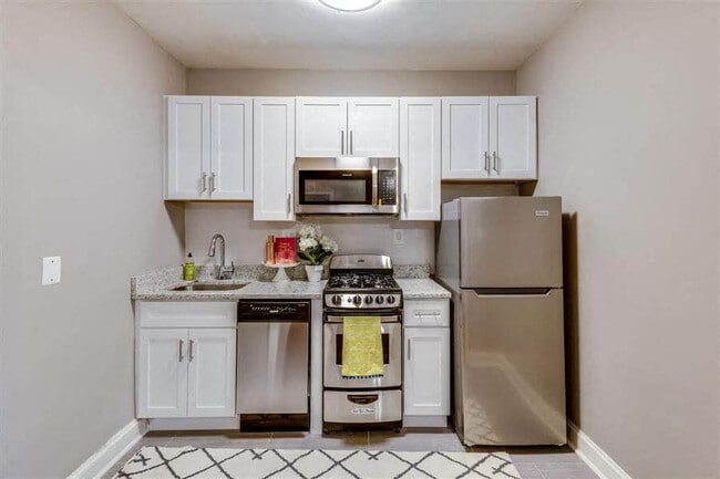 Studio kitchen with stainless steel appliances (staged)