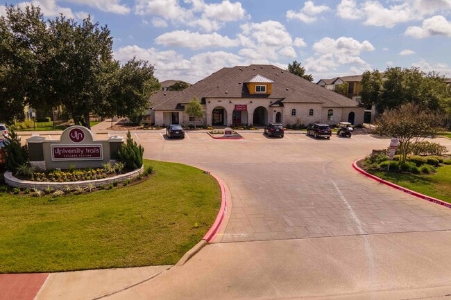 University-Trails-College-Station-Off-Campus-Apartments-Near-Texas-A&M-Main-Entrance-Monument-Sign-Clubhouse-Building-Exterior - University Trails