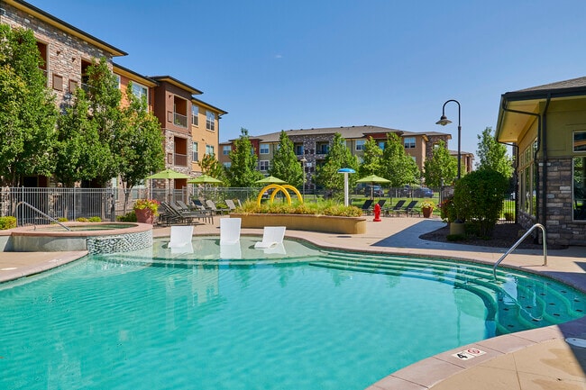 Resort-inspired pool with tanning shelf - Acadia at Cornerstar Apartments