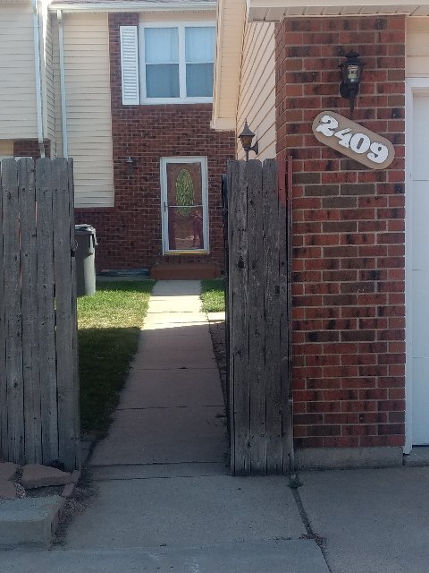 full fenced front yard (detached garage to the right) - 2409 E 16th St Townhome