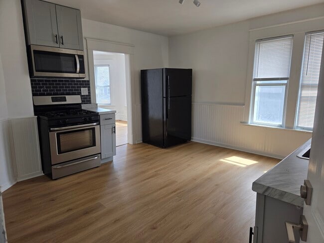 Kitchen with Stove and Microwave - 5706 22nd Ave Unit Upper