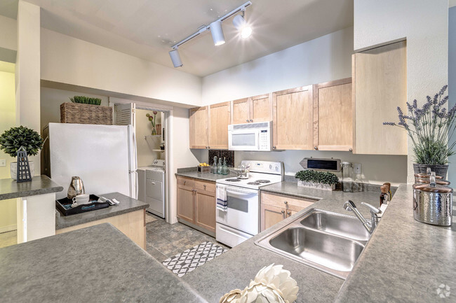 Open kitchens with energy efficient appliances, including dishwasher and mounted microwave - The Lodge at Redmond Ridge Rental