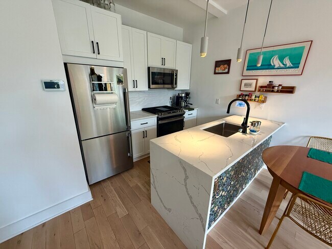 Kitchen with stainless steel appliances and quartz peninsula - 3916 14th St NW Unit 3
