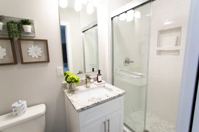 First-Floor Bathroom: Bright, modern bath with granite vanity and walk-in shower. - 421 Elysian Fields Rd Unit 5