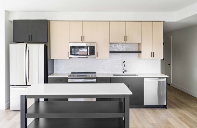 Discover culinary excellence at Modera Golden Triangle in Denver. Our gourmet kitchens feature quartz countertops, 42-inch custom cabinetry, and under-cabinet lighting, paired with an ENERGY STAR® stainless steel appliance package. - Modera Golden Triangle Apartments