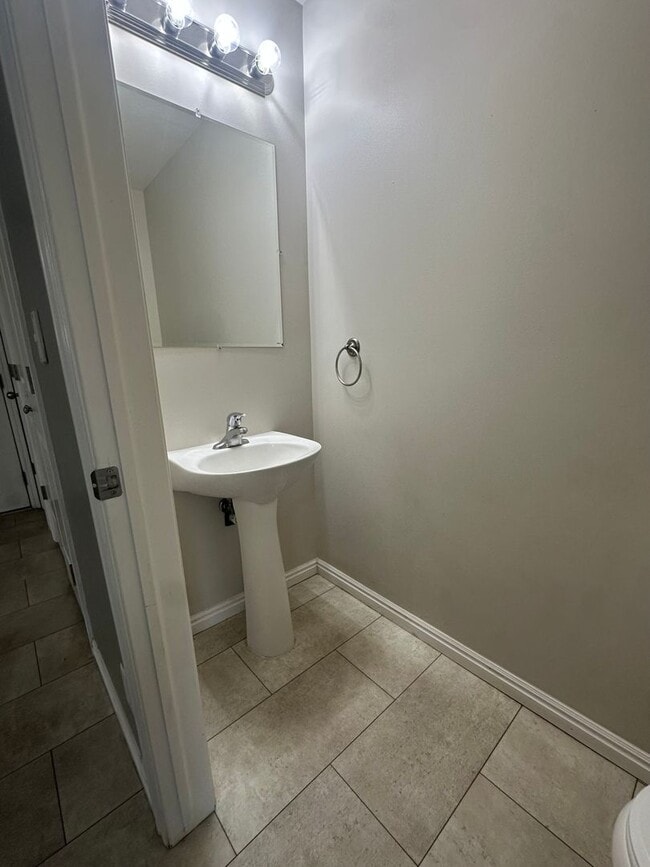 Photo - 2-Bedroom Townhome with Central AC and Covered Parking