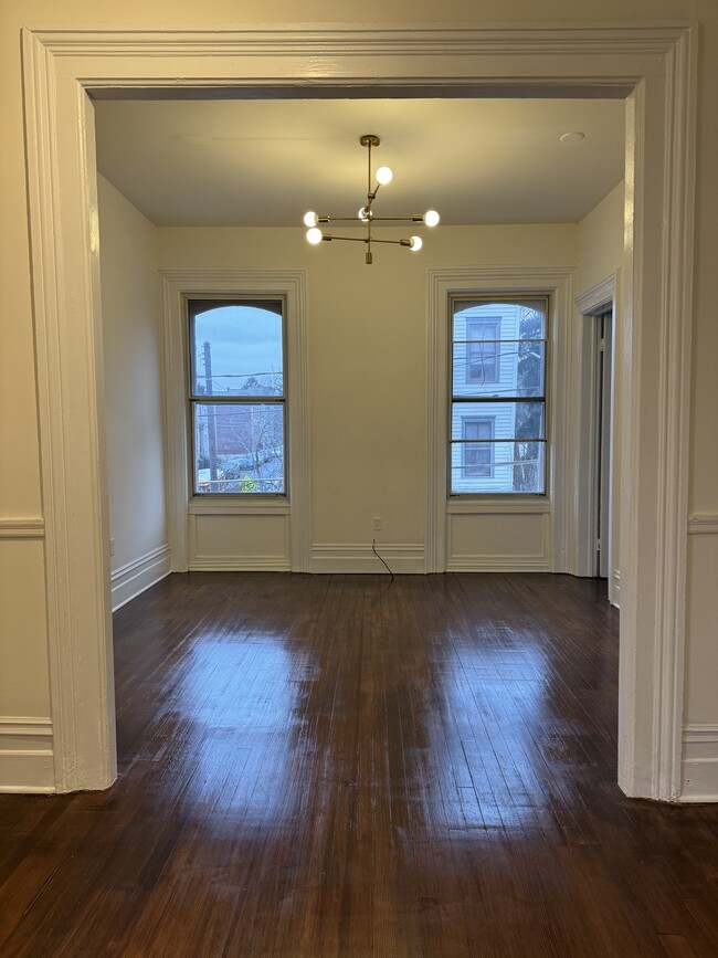 Front room faces street, large windows, high ceilings and plenty of light! - 118 Philip St Townhome