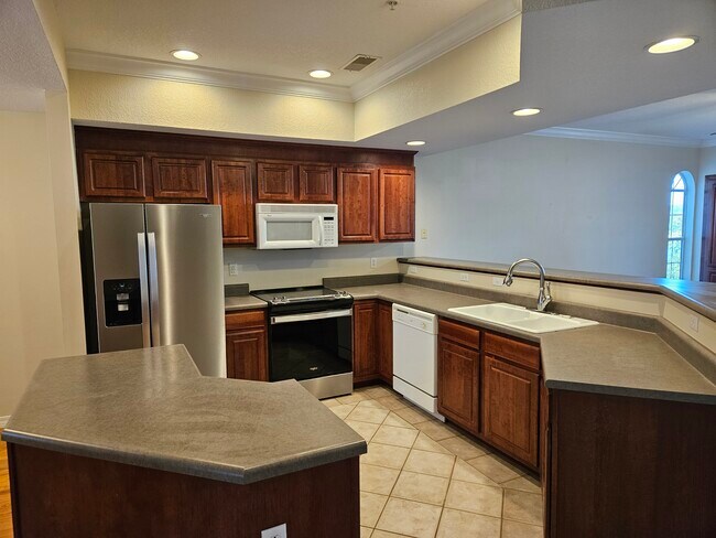 Kitchen with breakfast bar, new refrigerator and oven - 680 Emerald Pointe Dr Unit Bldg #3 #5
