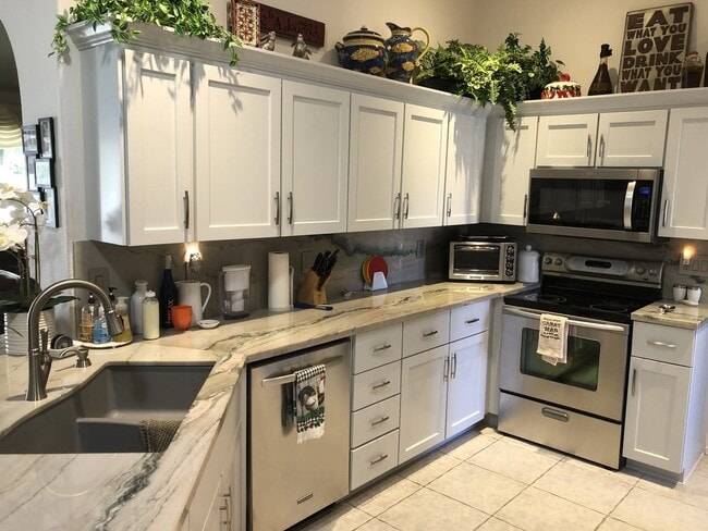 Kitchen - Stone countertops, 5 appliances, sliding drawers. - 9513 E Champagne Dr