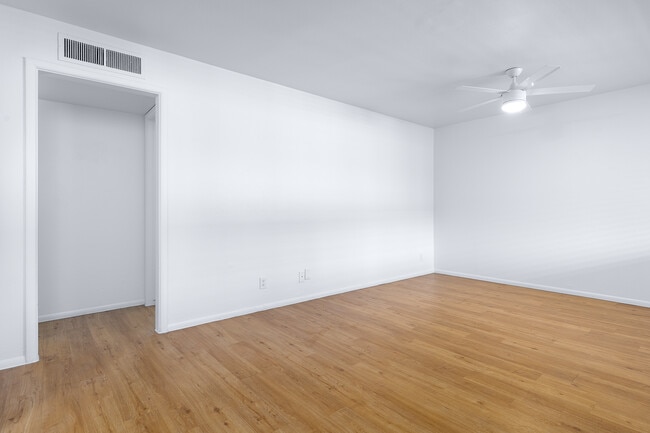 Large living space and neutral new paint with wood look floors - The Parker