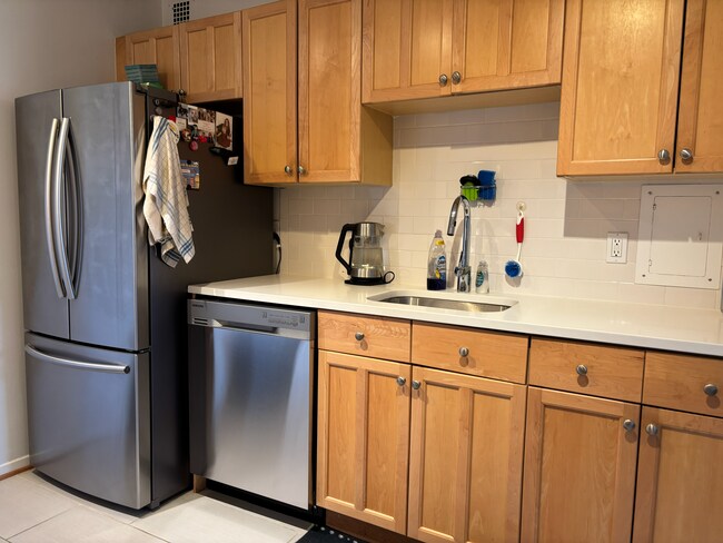 Kitchen - stainless steel fridge and dishwasher - all Samsung appliances.