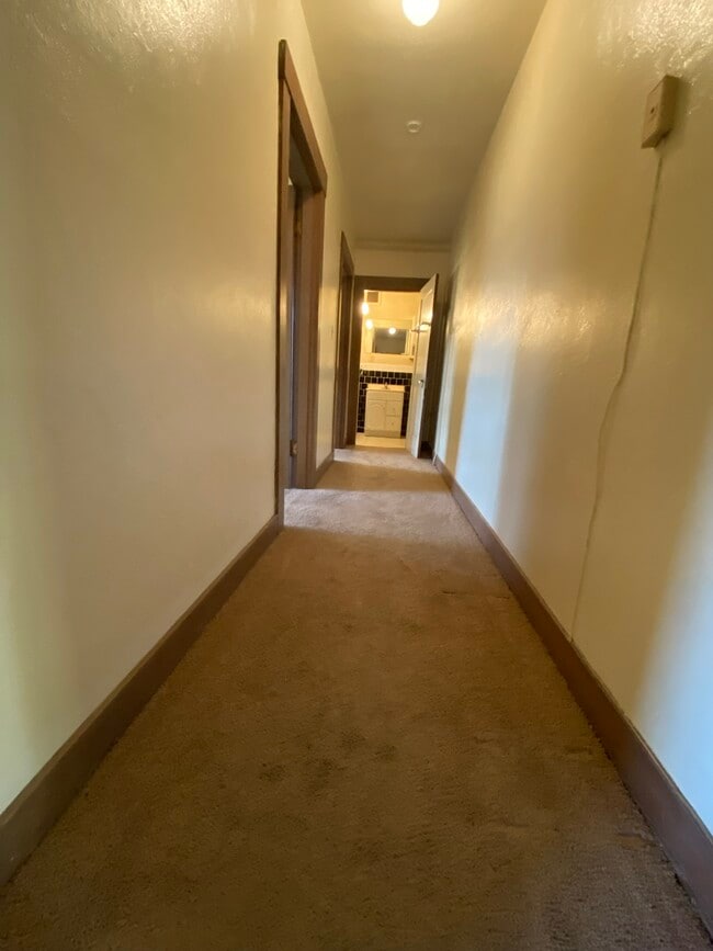 Carpeted hallway and bedroom. - 319 N 8th St