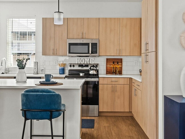 Kitchen with light cabinets & stainless steel appliances