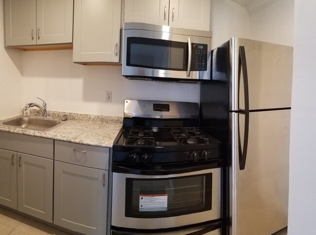 Brand new kitchen with stainless steel appliances include full size fridge, ventless microwave vent hood, gas operated stove, new back splash, and soft close hinges - 830 Spruce Ct Unit #A