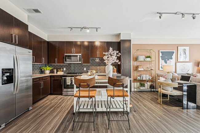 Enjoy seamless living in this open-concept home, where a designer kitchen meets a bright living space. - The Heights at Goose Creek Village